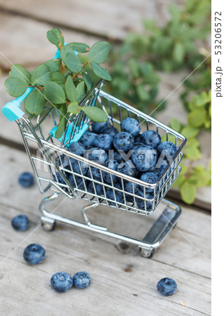 Fresh raw blueberries with leaves on wooden 53206572