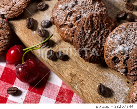 Oatmeal chocolate cookies with coffee grains and cherry. Sun flare Oatmeal chocolate cookies with coffee grains and cherry. Sun flare 53207244