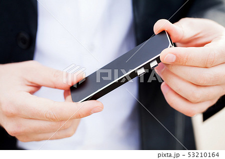 Man holding mini adapter for laptops and flash memory Man holding mini adapter for laptops and flash memory 53210164