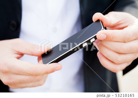 Man holding mini adapter for laptops and flash memory 53210165