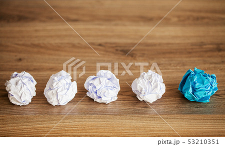 Creative idea concept. Crumpled paper balls on wood background 53210351