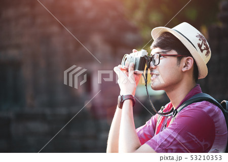 Young Man Photographer Traveler with backpack Young Man Photographer Traveler with backpack 53210353