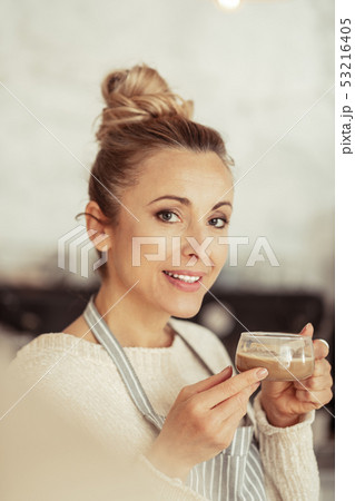 Gorgeous woman raising up her coffee cup. Gorgeous woman raising up her coffee cup. 53216405
