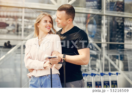 Beautiful couple standing in a airport Beautiful couple standing in a airport 53216509