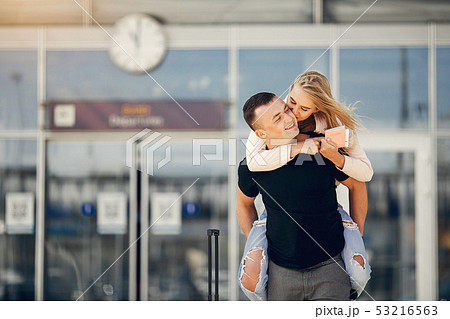 Beautiful couple standing in a airport Beautiful couple standing in a airport 53216563