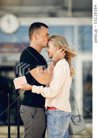 Beautiful couple standing in a airport Beautiful couple standing in a airport 53216564