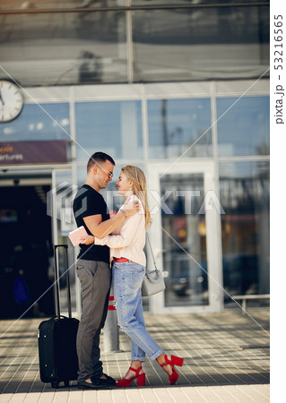 Beautiful couple standing in a airport Beautiful couple standing in a airport 53216565