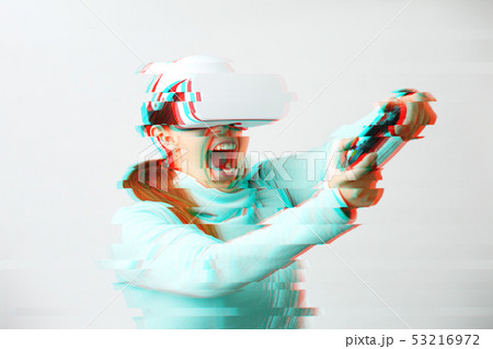 Woman with virtual reality headset is playing game. Image with glitch effect. 53216972