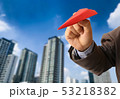 Business man in suit holding red paper airplane 53218382