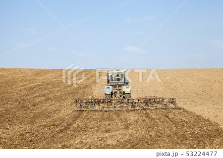 Harrowing the soil with tine harrows Harrowing the soil with tine harrows 53224477