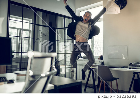 Mature businessman jumping high after successful deal Mature businessman jumping high after successful deal 53226293