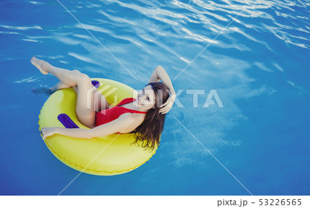 Woman in bikini on the inflatable mattress 53226565