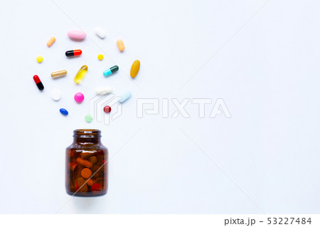 Colorful tablets with capsules and pills on white. Colorful tablets with capsules and pills on white. 53227484