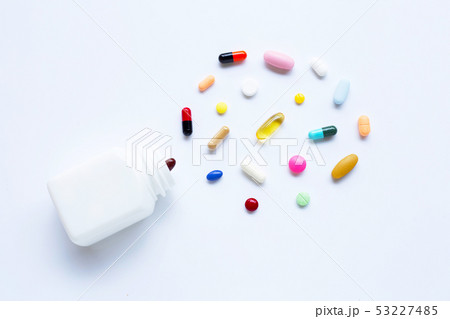 Colorful tablets with capsules and pills on white. Colorful tablets with capsules and pills on white. 53227485