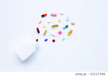 Colorful tablets with capsules and pills on white. Colorful tablets with capsules and pills on white. 53227486