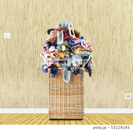 Beige straw basket full of dirty Laundry Beige straw basket full of dirty Laundry 53229183