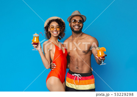 Cheerful african american couple enjoying fresh tropical cocktails Cheerful african american couple enjoying fresh tropical cocktails 53229298