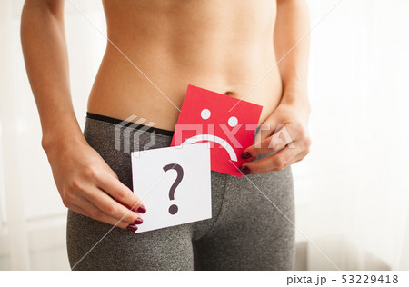 Vaginal or urinary infection and problems concept. Young woman holds paper with sad smile above 53229418