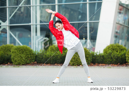 Fitness girl. Young sports woman stretching in the modern city. Healthy lifestyle in the big city 53229873