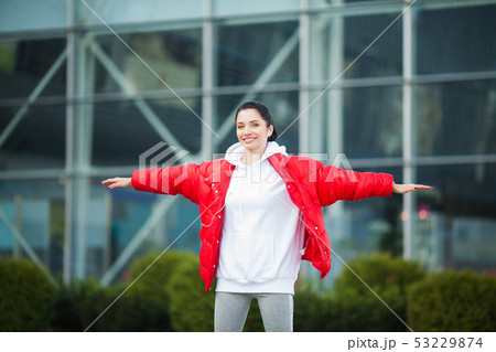 Fitness girl. Young sports woman stretching in the modern city. Healthy lifestyle in the big city 53229874