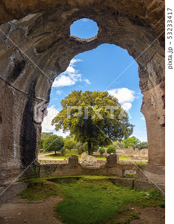Villa Adriana - Rome Tivoli - Italy - large tree seen through large crumbled walls chasm in ancient 53233417
