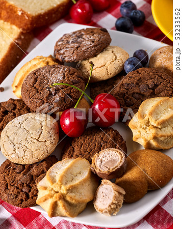 Chocolate oatmeal cookies and sand heart shape cake with blueberries Chocolate oatmeal cookies and sand heart shape cake with blueberries 53233562