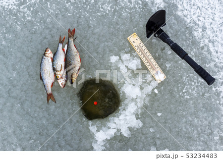 Ice hole fishing. Winter fishing in freezing cold 53234483
