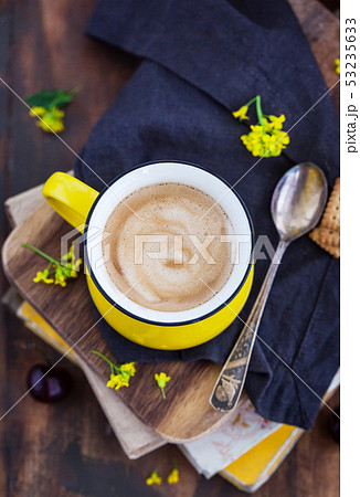 Bright yellow mug of fresh hot black coffee  53235633
