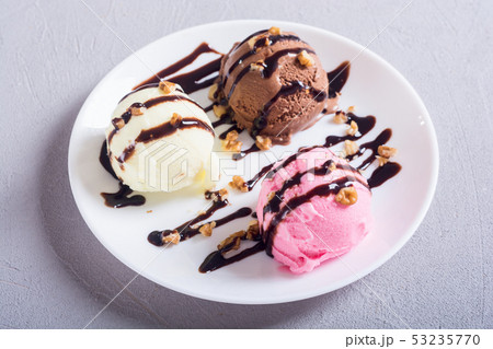 Ice cream with walnuts and chocolate topping Ice cream with walnuts and chocolate topping 53235770