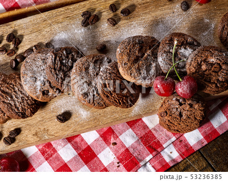 Oatmeal chocolate cookies with coffee grains and cherry. Sun flare 53236385