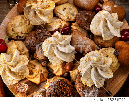 Oatmeal cookies, crispy wafer rolls on tier cake stand Oatmeal cookies, crispy wafer rolls on tier cake stand 53236702