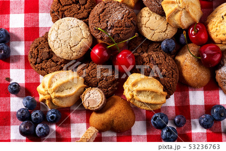 Cookies and sand biscuit on tier cake stand with blueberry chocolate 53236763
