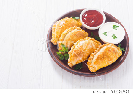 Latin American baked beef empanadas with sauce Latin American baked beef empanadas with sauce 53236931