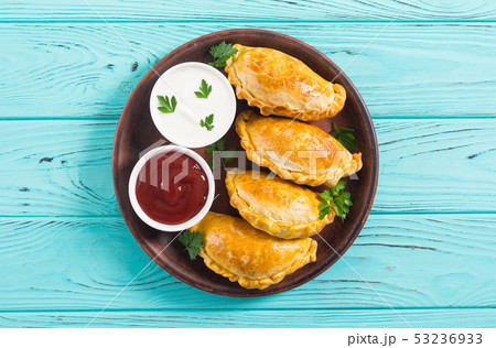 Latin American baked beef empanadas with sauce 53236933