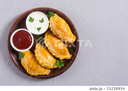 Latin American baked beef empanadas with sauce 53236934