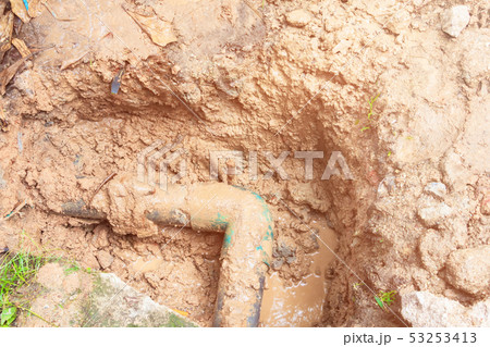broken pipe in hole with water motion at roadside broken pipe in hole with water motion at roadside 53253413