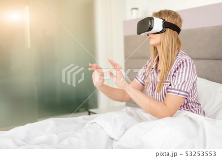 young blonde girl using virtual reality equipment 53253553