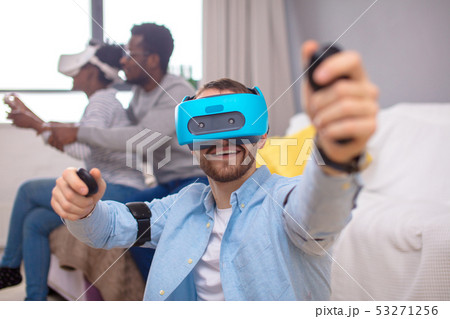 Multiracial group of friends having fun trying on 3D virtual reality goggles. 53271256
