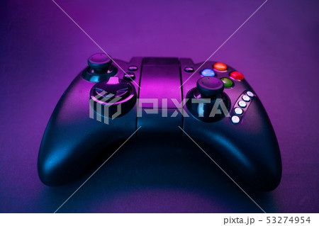 Gamepad on violet table background. 53274954