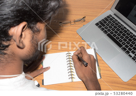 Businessman writing in his diary. Open notebook Businessman writing in his diary. Open notebook 53280440