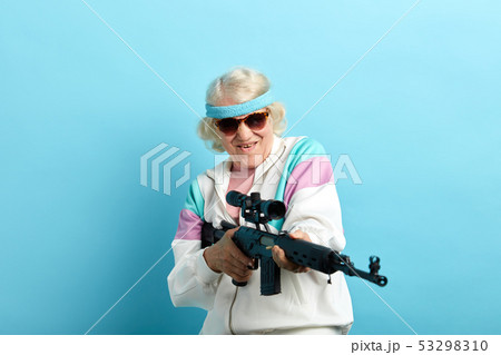 Nice looking grandmother- FBI agent aiming with a rifle, ready to shoot, poster. Nice looking grandmother- FBI agent aiming with a rifle, ready to shoot, poster. 53298310