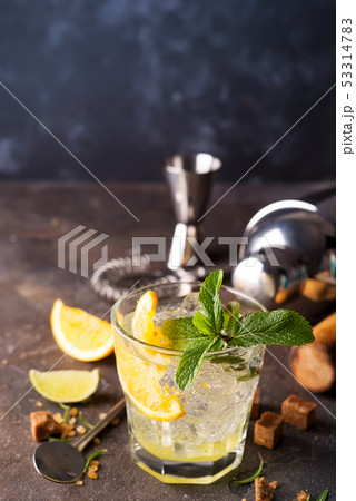 Mojito or Caipirinha cocktail. Brown sugar and an empty glass on stone Mojito or Caipirinha cocktail. Brown sugar and an empty glass on stone 53314783