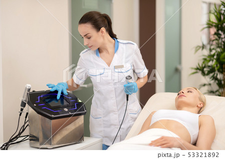 Dermatologist doing anti-aging procedures for client in beauty salon 53321892