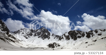 Panoramic view on high snowy mountains and blue 53327134