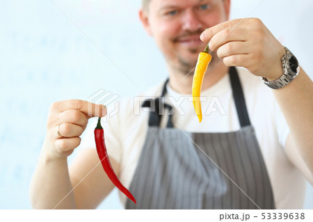 Smiling Chef Holding Red Organic Cayenne Pepper 53339638