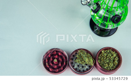 Medical marijuana buds with bong and grinder 53345729