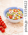 Rice salad with pork steak, tomatoes, corn seeds and tomatoes. 53354622
