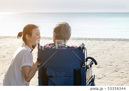 Mother and daughter sit together in front of the Mother and daughter sit together in front of the 53356344