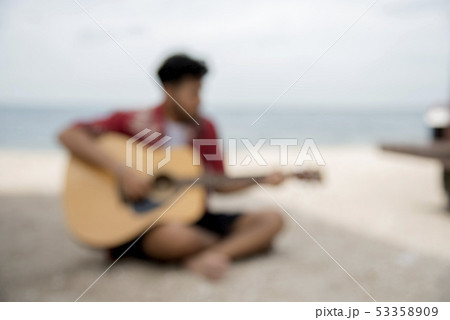 Blurred Background of young man playing guitar on Blurred Background of young man playing guitar on 53358909