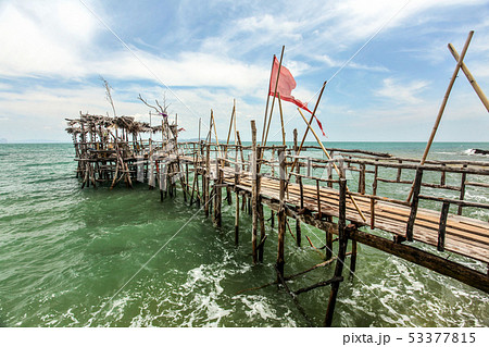 Spooky old shaky wooden pier that looks fragile and not quite safe near sea gypsies village at Moo 7 53377815